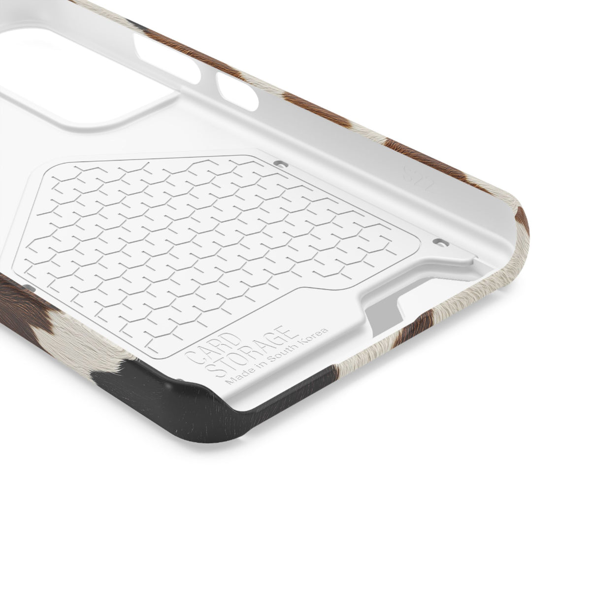 Brown cow print phone case with card holder, lifestyle view