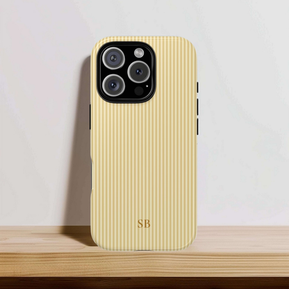 Monogrammed butter yellow striped tough phone case on a neutral background