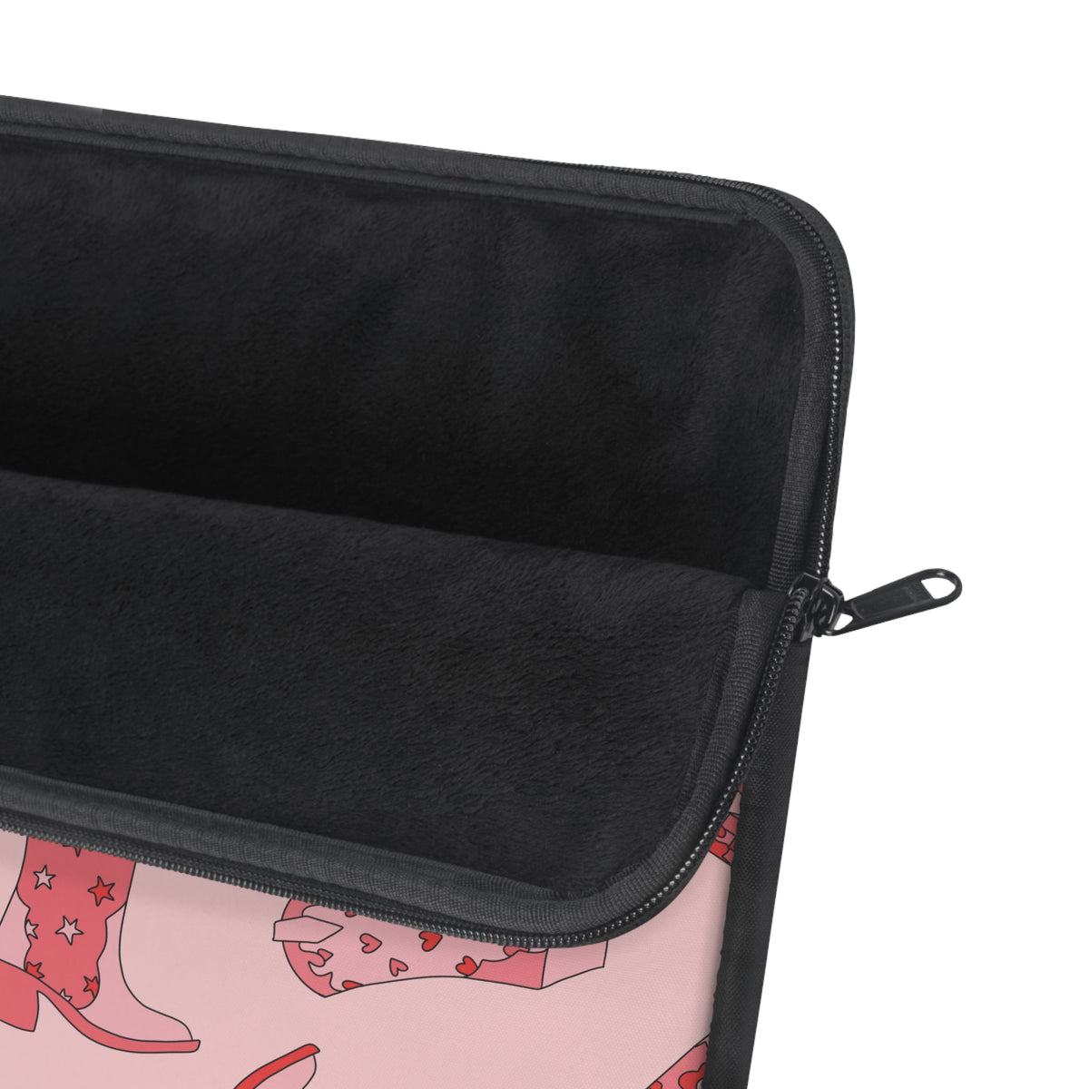Close-up of the pink and red cowboy boot pattern on the laptop sleeve