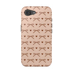 Brown ribbon bows and hearts on a peach pink MagSafe phone case