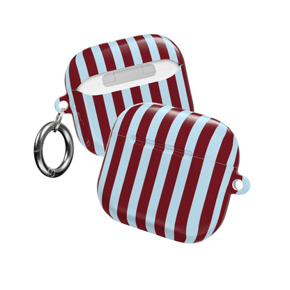 Striped AirPod case clipped to a bag strap