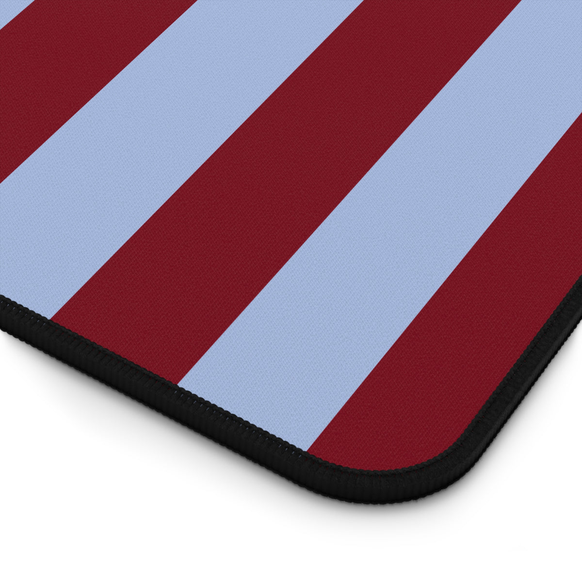 Burgundy blue striped desk mat on a home office desk