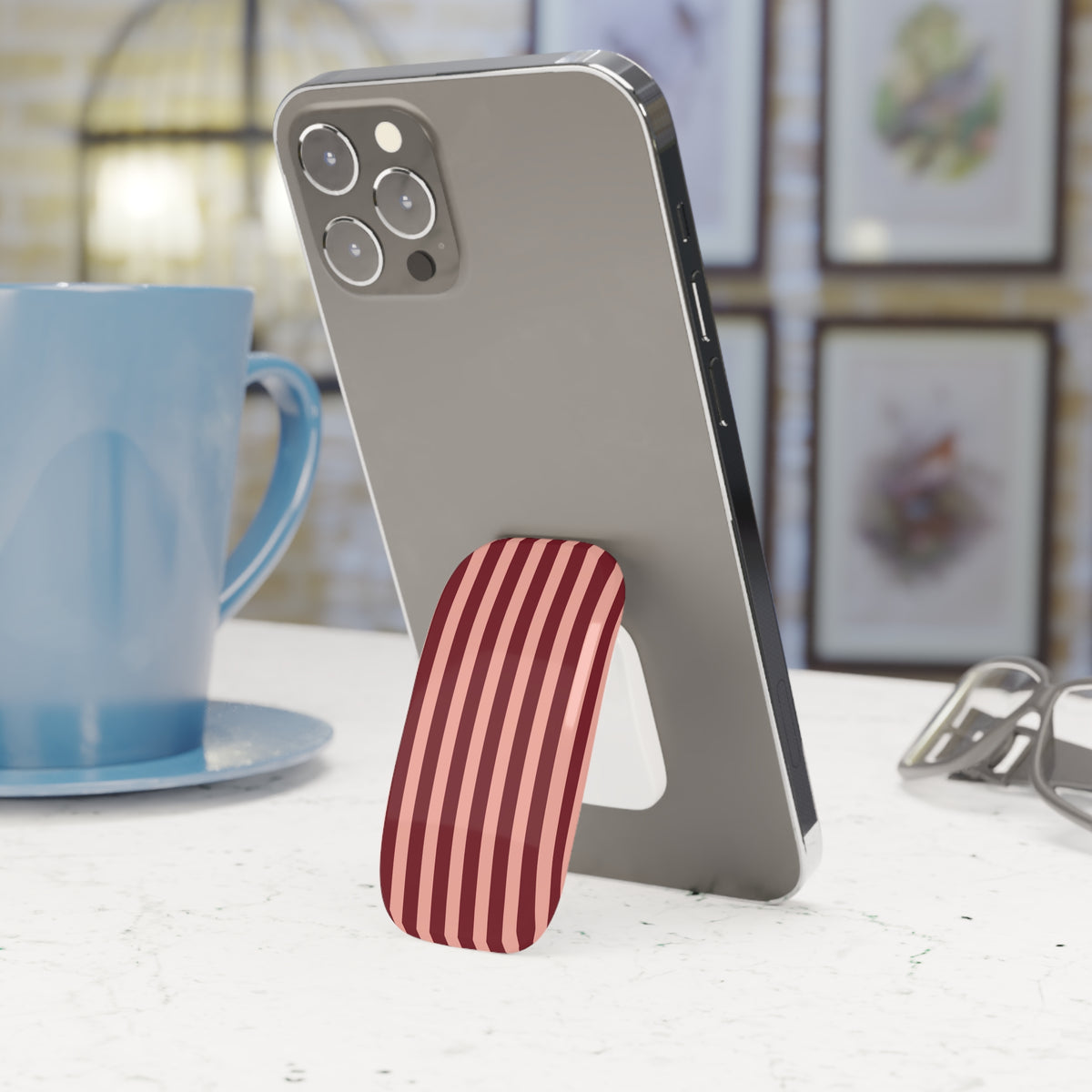 Burgundy blush striped phone grip used as a kickstand
