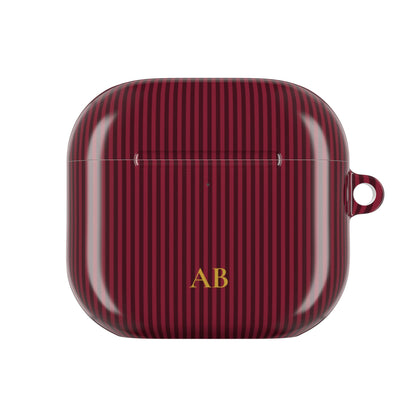 Burgundy striped personalized AirPod case held in hand
