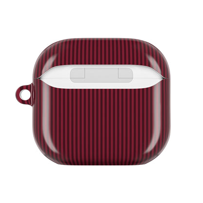 Monogrammed burgundy striped AirPod case on a neutral background