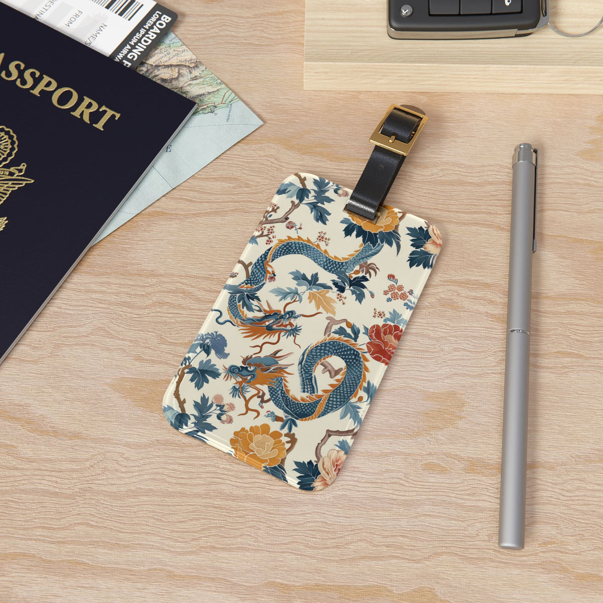 Chinoiserie dragon luggage tag attached to a suitcase handle