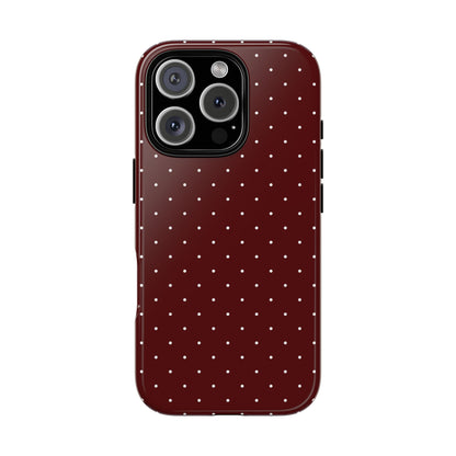 Deep red polka dot tough phone case held in hand