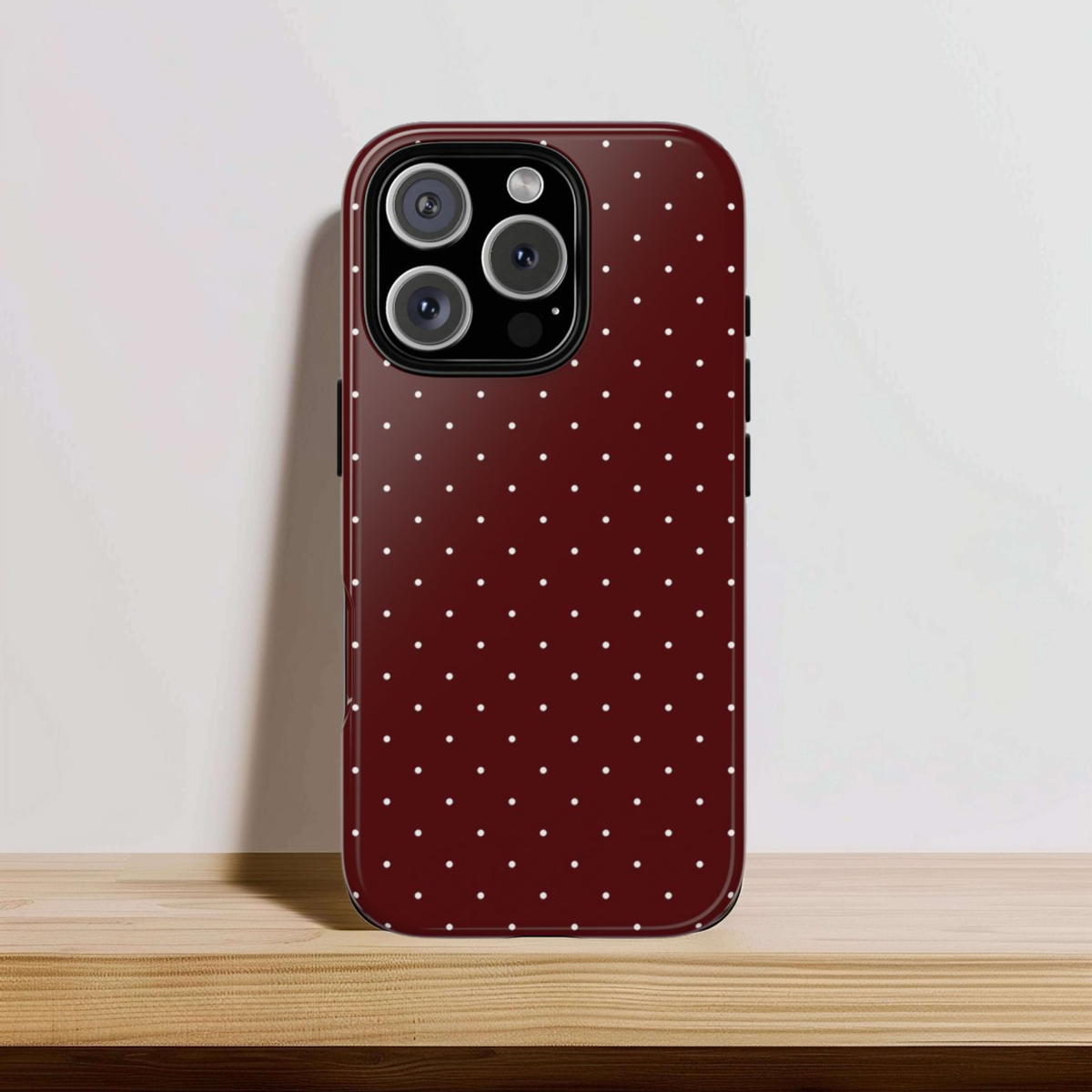 Cream pin dots on dark red, print for a tough phone case