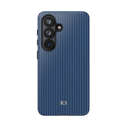 Navy striped dual-layer phone case with a yellow monogram held in hand