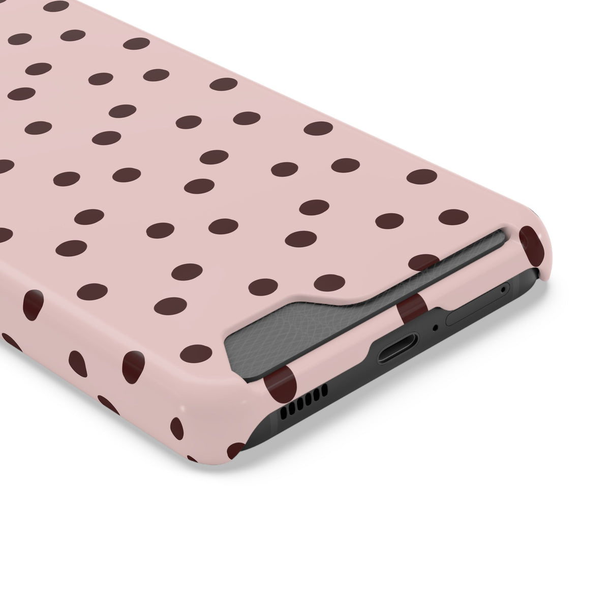 Pink and brown polka dot phone case with card holder, angled view
