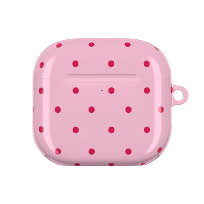 Pink and red polka dot AirPod case held in hand
