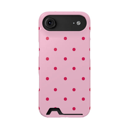 Pink phone case with red dots held in hand