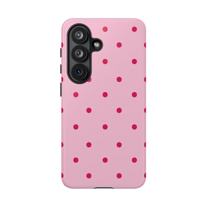 Pink and red dotted tough phone case held in hand