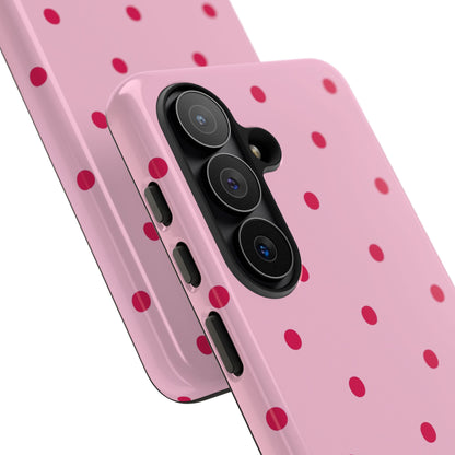 Pink tough phone case with raised camera edge and red dots