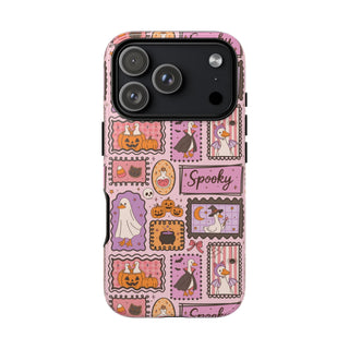Pink Halloween stamps tough phone case held in hand