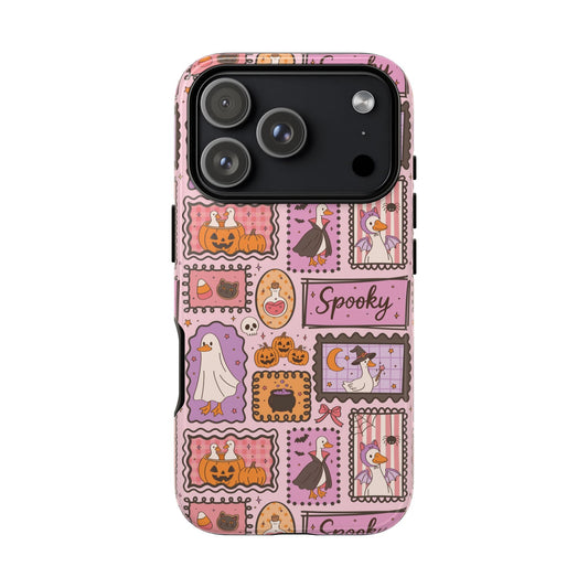 Pink Halloween stamps tough phone case held in hand