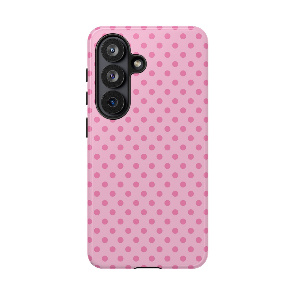 Polka dot tough phone case in pink, held in hand