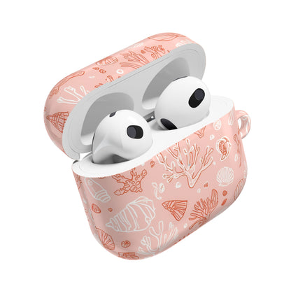 Coastal seashell pattern on a blush pink AirPod case