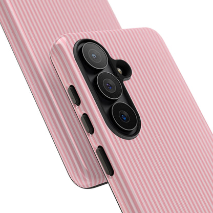 Pink striped tough phone case styled with everyday accessories
