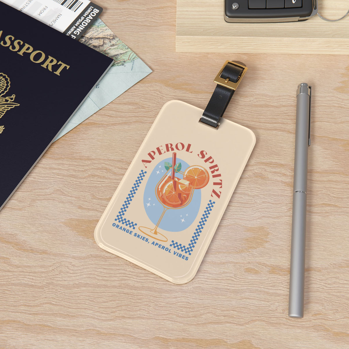 Spritz cocktail luggage tag attached to a suitcase handle